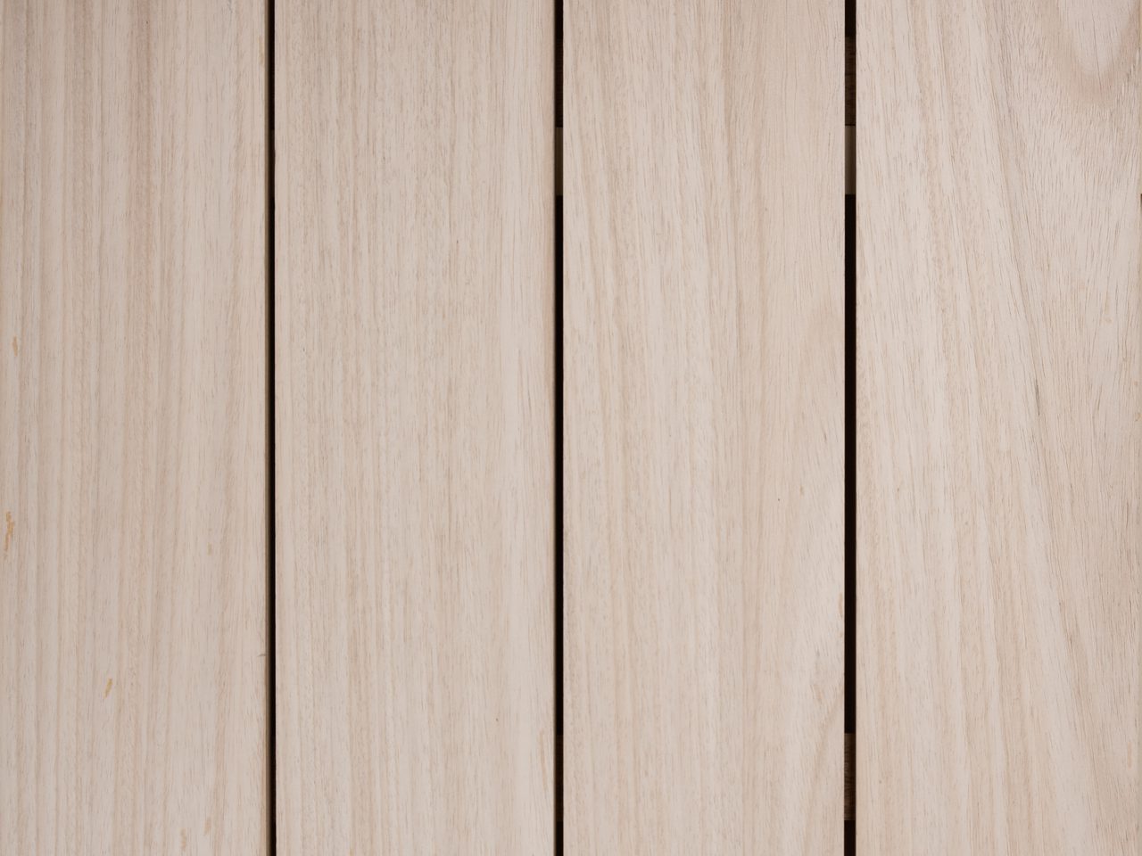 Close-up of vertical light wood planks with subtle grain and small gaps.