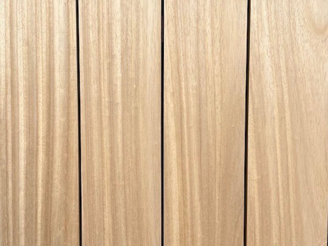 Vertical light-brown wooden boards with visible grain and small screws along the edges.
