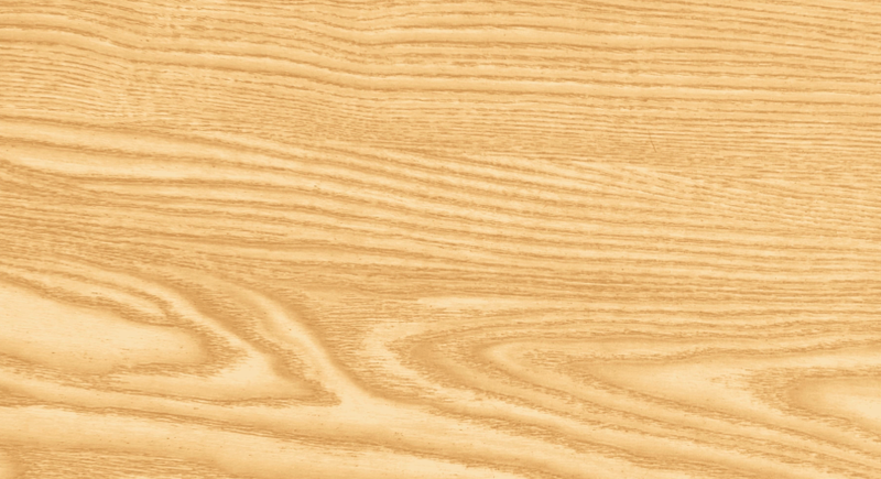 Close-up of a light wood surface showing natural grain patterns and soft swirls in warm beige tones.