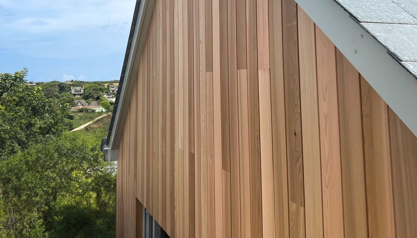The top elevation of a house with vertical western red cedar cladding.
