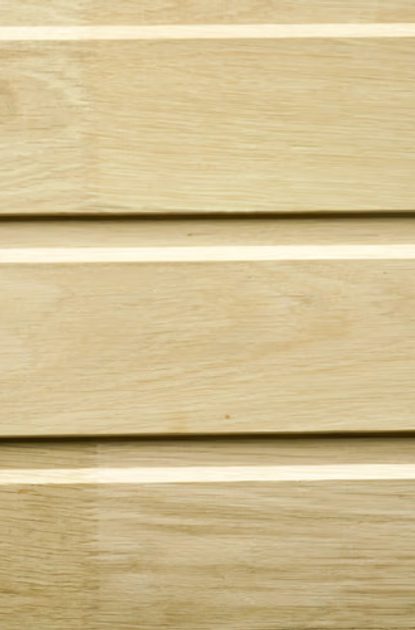 Close-up of light wooden planks laid horizontally, featuring natural grain patterns and thin gaps between boards.