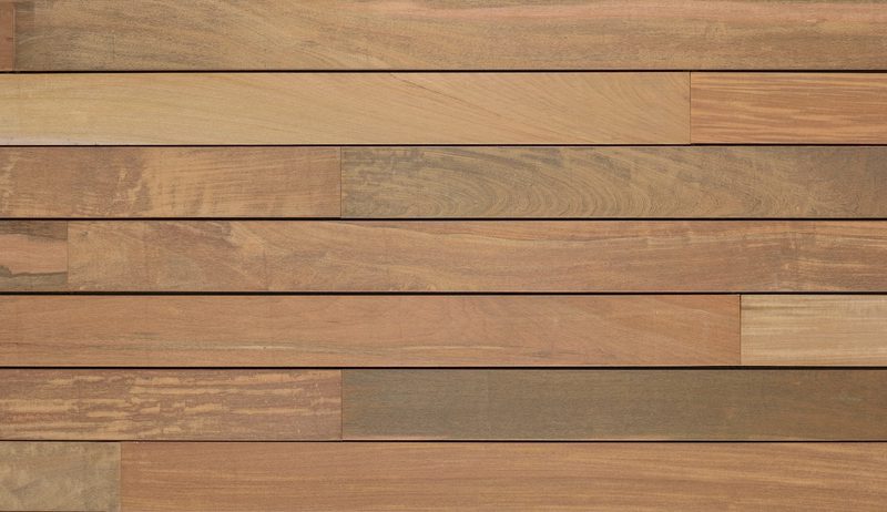 Row of warm brown wooden planks in varying shades, aligned horizontally with visible grain and narrow seams.