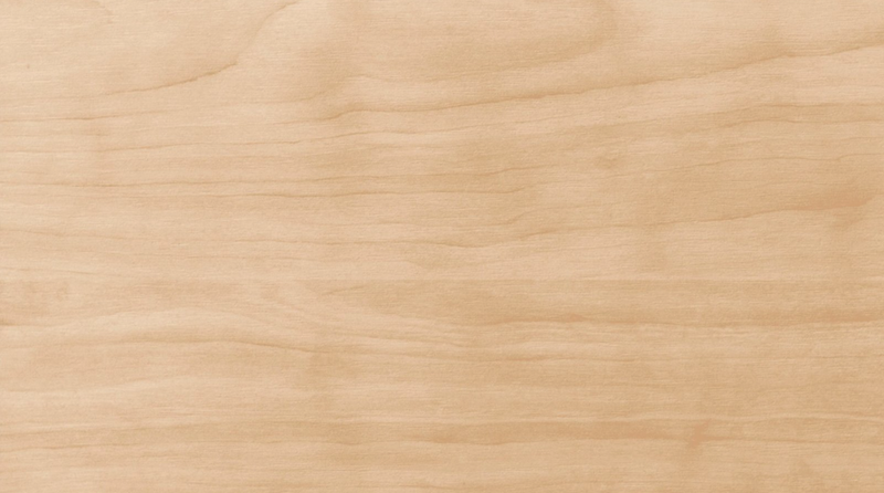 Light wooden surface with subtle grain patterns and warm beige color.