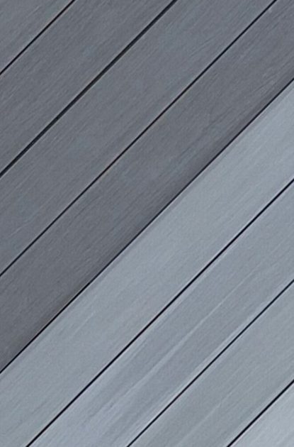 Diagonal grey wooden deck boards with visible grain in alternating light and dark shades.
