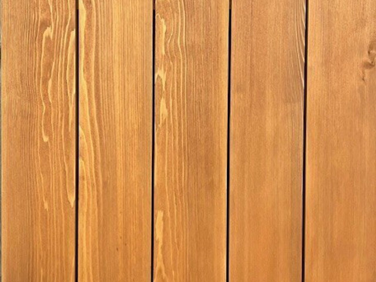 Vertical wooden planks with warm brown tones, showing wood grain and knots.