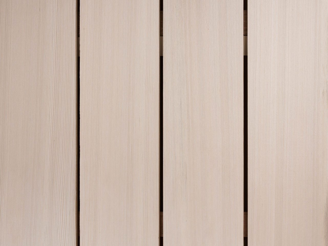 Close-up of vertical light beige wooden planks with small gaps, showing subtle grain and a smooth, even surface.