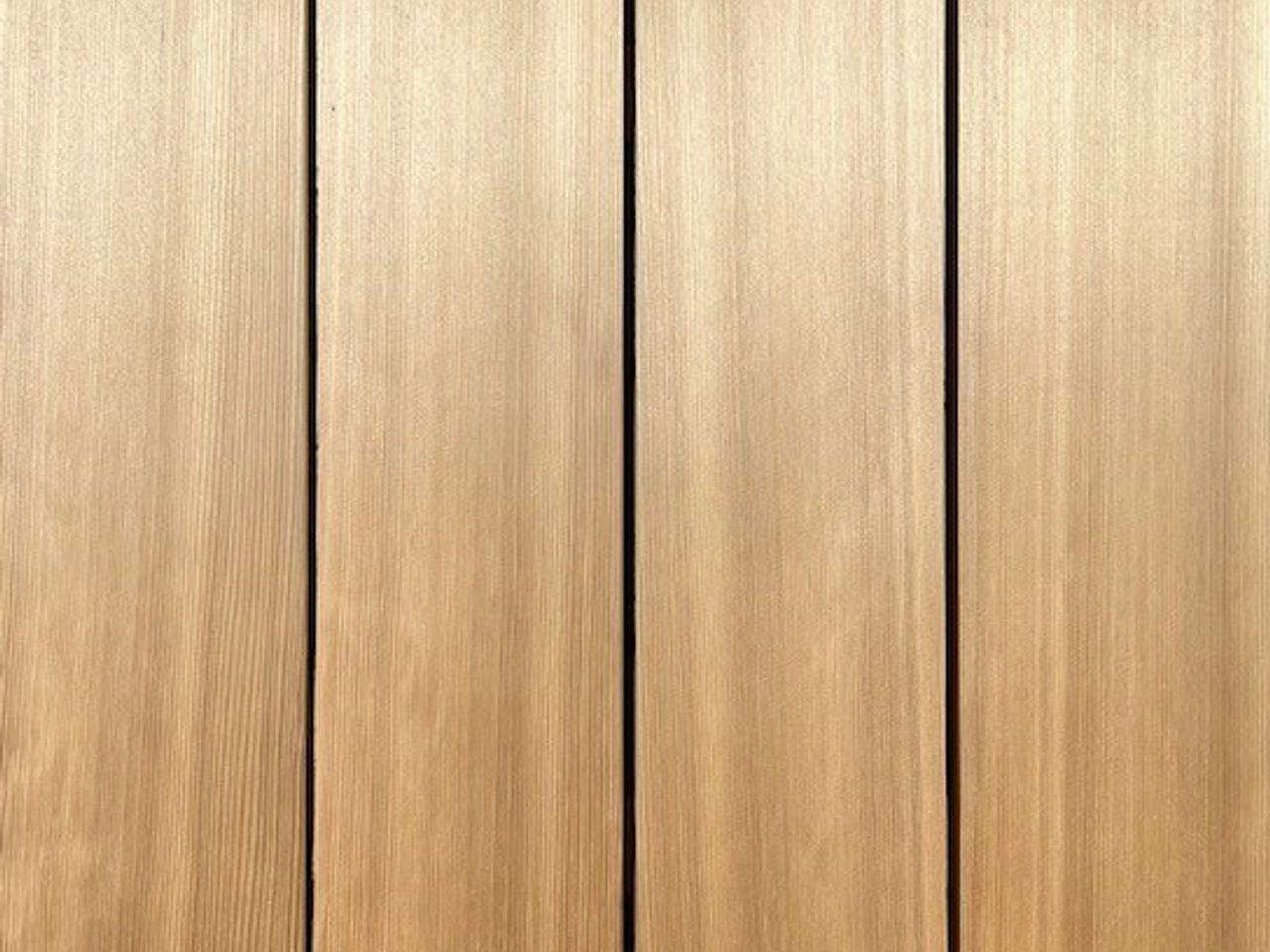 Vertical wooden planks with visible screws at the edges; light brown wood grain and narrow gaps between boards.