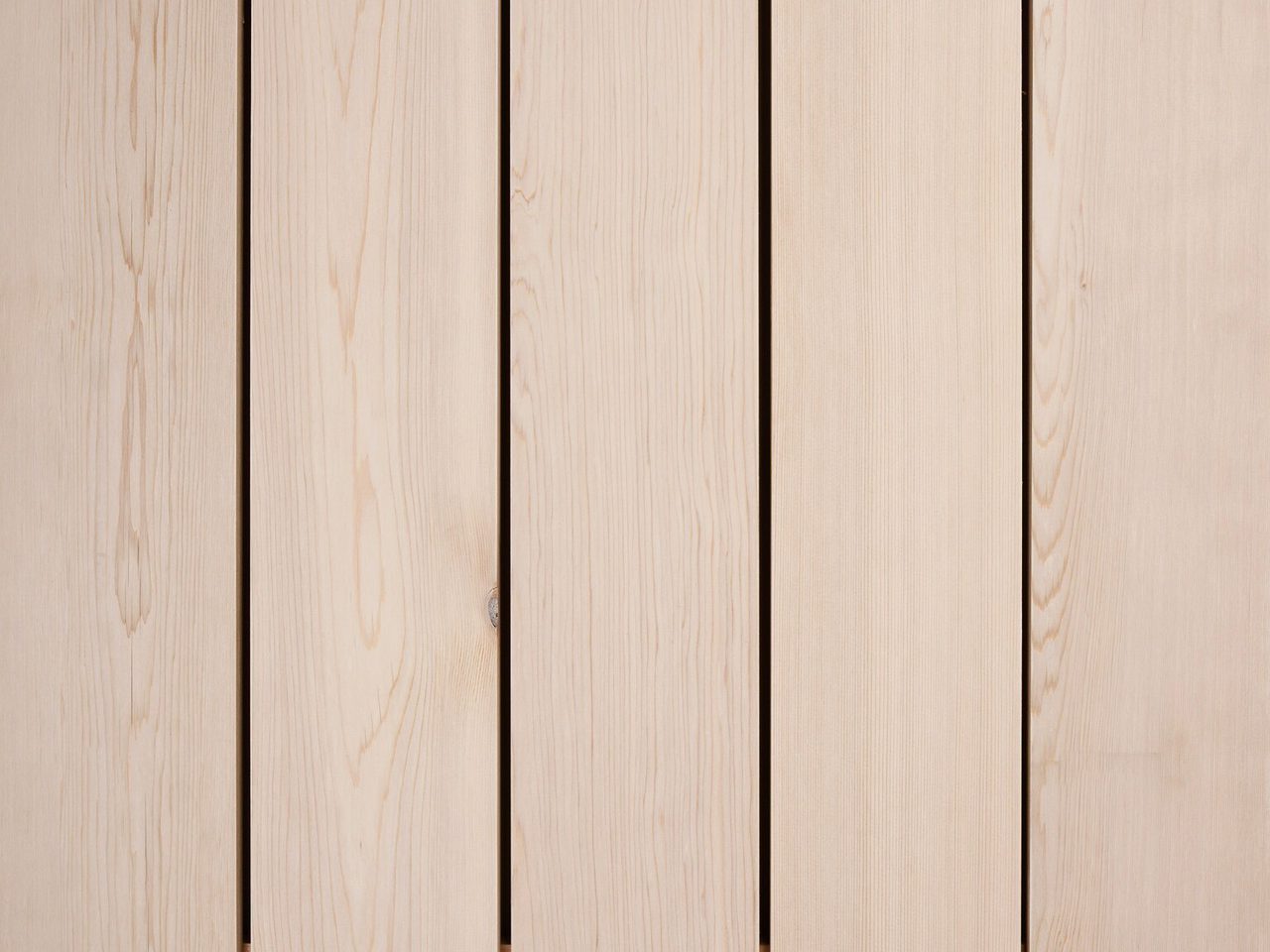 Light beige wooden planks arranged vertically with small gaps between boards, showing natural grain and knots.