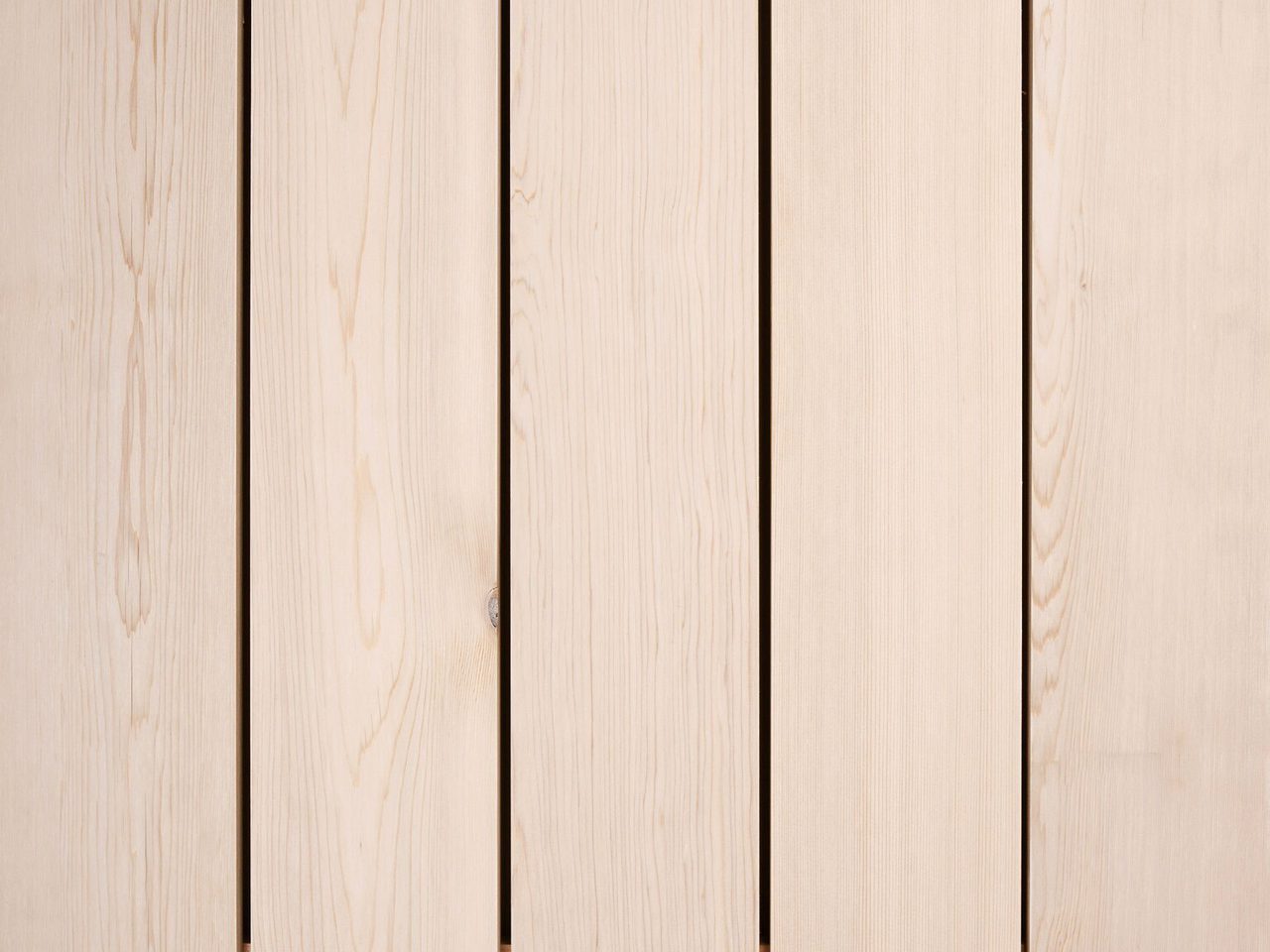Vertical light wood planks with visible grain and narrow gaps, forming a wooden surface.