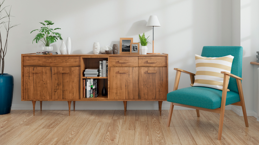Mid-century wooden sideboard with cabinets and open shelves, decorative items and a lamp; teal chair with a striped cushion beside a tall blue vase with branches.