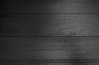 Dark wooden planks run horizontally with visible grain and a subtle gloss, forming a textured background.