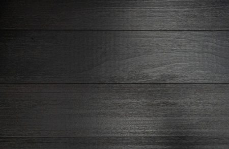 Dark wooden planks run horizontally with visible grain and a subtle gloss, forming a textured background.
