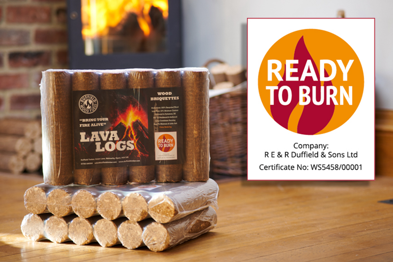 Lava log wood briquettes stacked on a wooden floor, with wrapped bundles beneath and a warm fireplace glowing in the background; a Ready to Burn certificate graphic on the right.