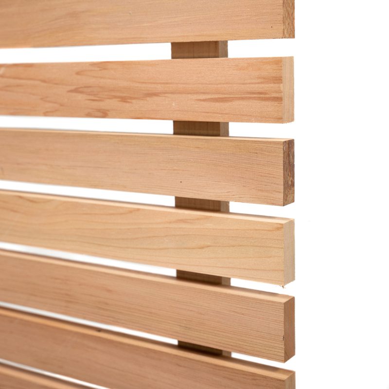 Close-up of light wood horizontal slats with small gaps, forming a wooden screen against a white background.
