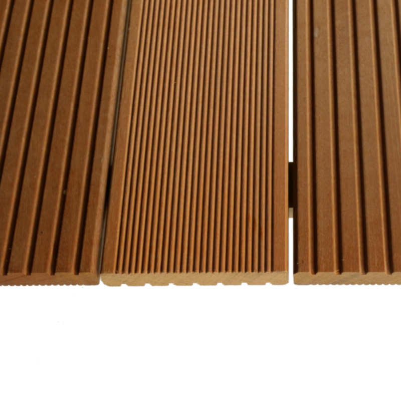 Close-up of brown grooved wooden decking planks with parallel ridges and a narrow white gap between two boards.