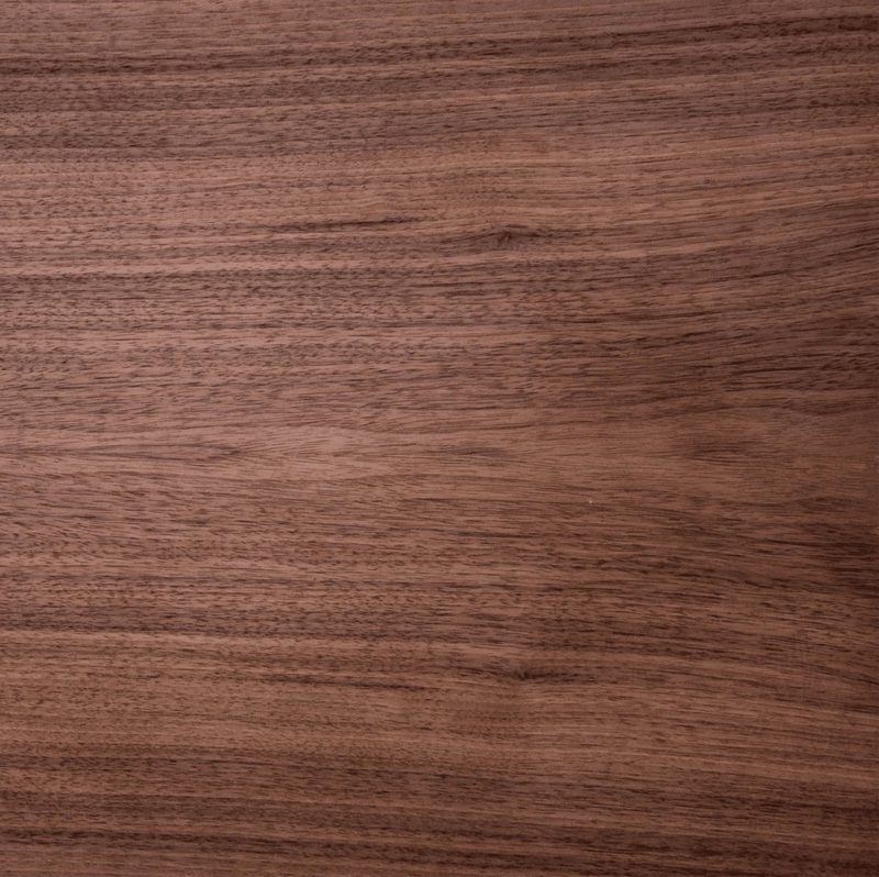 Close-up of a brown wooden surface with visible grain patterns and subtle markings.
