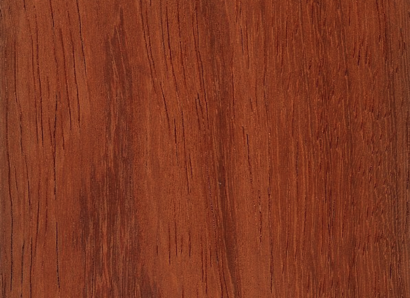 Close-up of reddish-brown wood grain with dark vertical streaks.