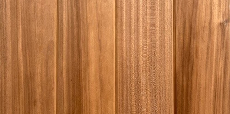 Close-up of vertical wooden planks with natural grain patterns and warm brown tones.