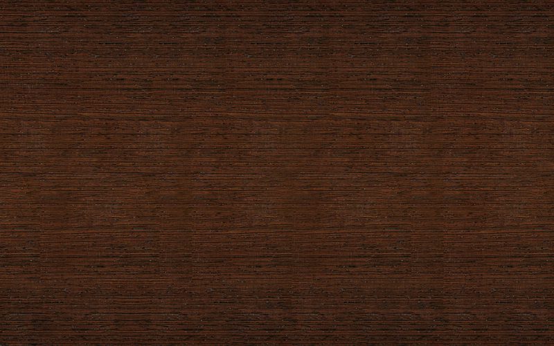 Close-up of a dark brown wood surface with fine horizontal grain and subtle texture.