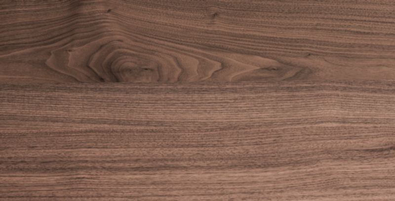 Close-up of a brown wooden surface with prominent grain patterns and subtle knots.