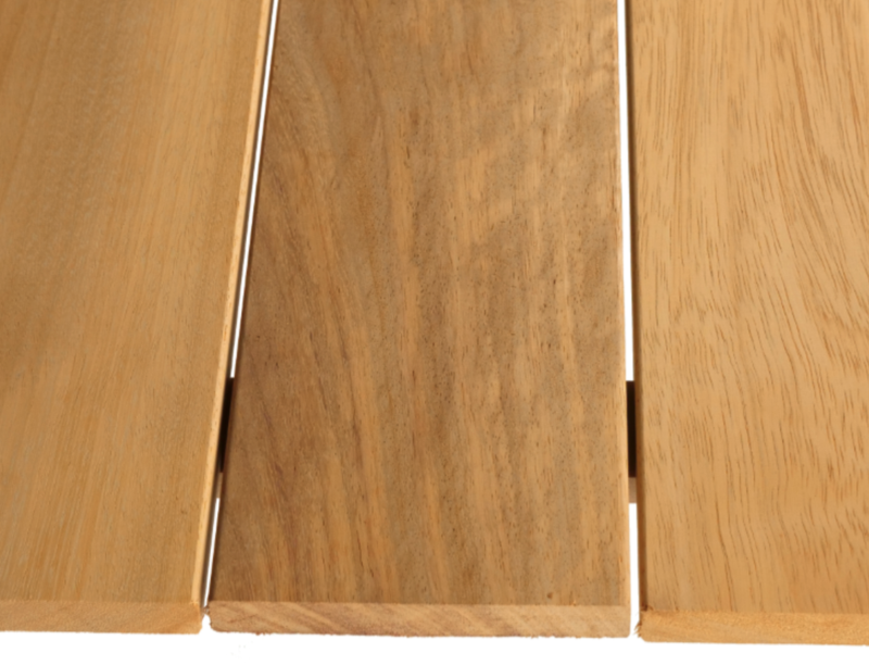 Three vertical wooden planks with thin white gaps between them, showing natural wood grain from light to medium brown, with the center plank darker.