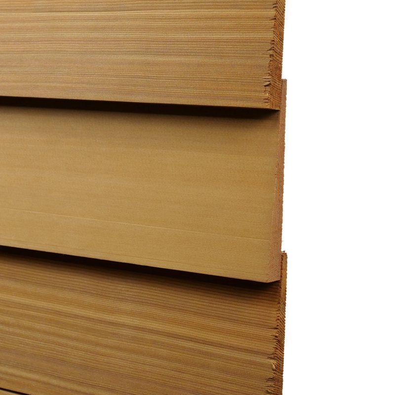 Close-up of light-brown wooden boards stacked horizontally, showing wood grain and beveled edges against a white background.