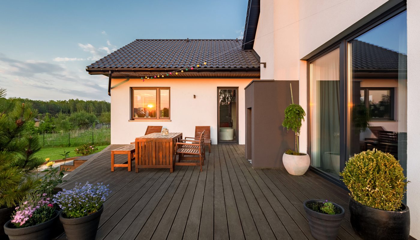 A beautiful timber deck at the back of a house overlooking the countryside.