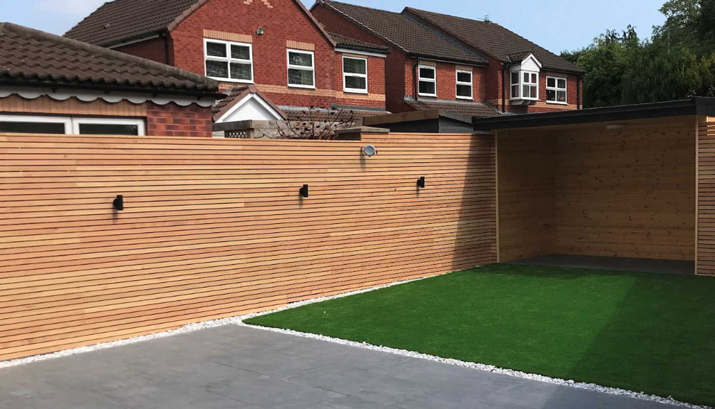 A wider shot of a modern, stylish garden with douglas fir fencing.