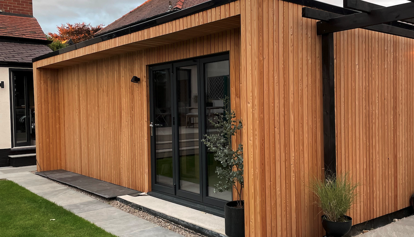 Siberian Larch cladding in a shadow gap profile on a garden room outbuilding.