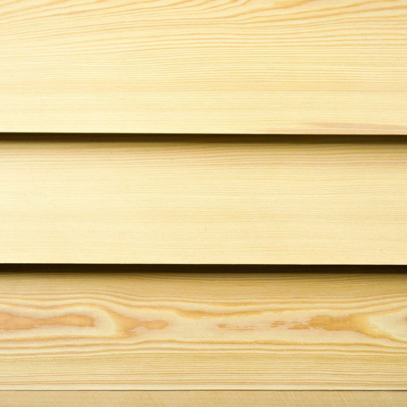 Close-up of three pale wooden planks with subtle grain patterns and narrow gaps between them.