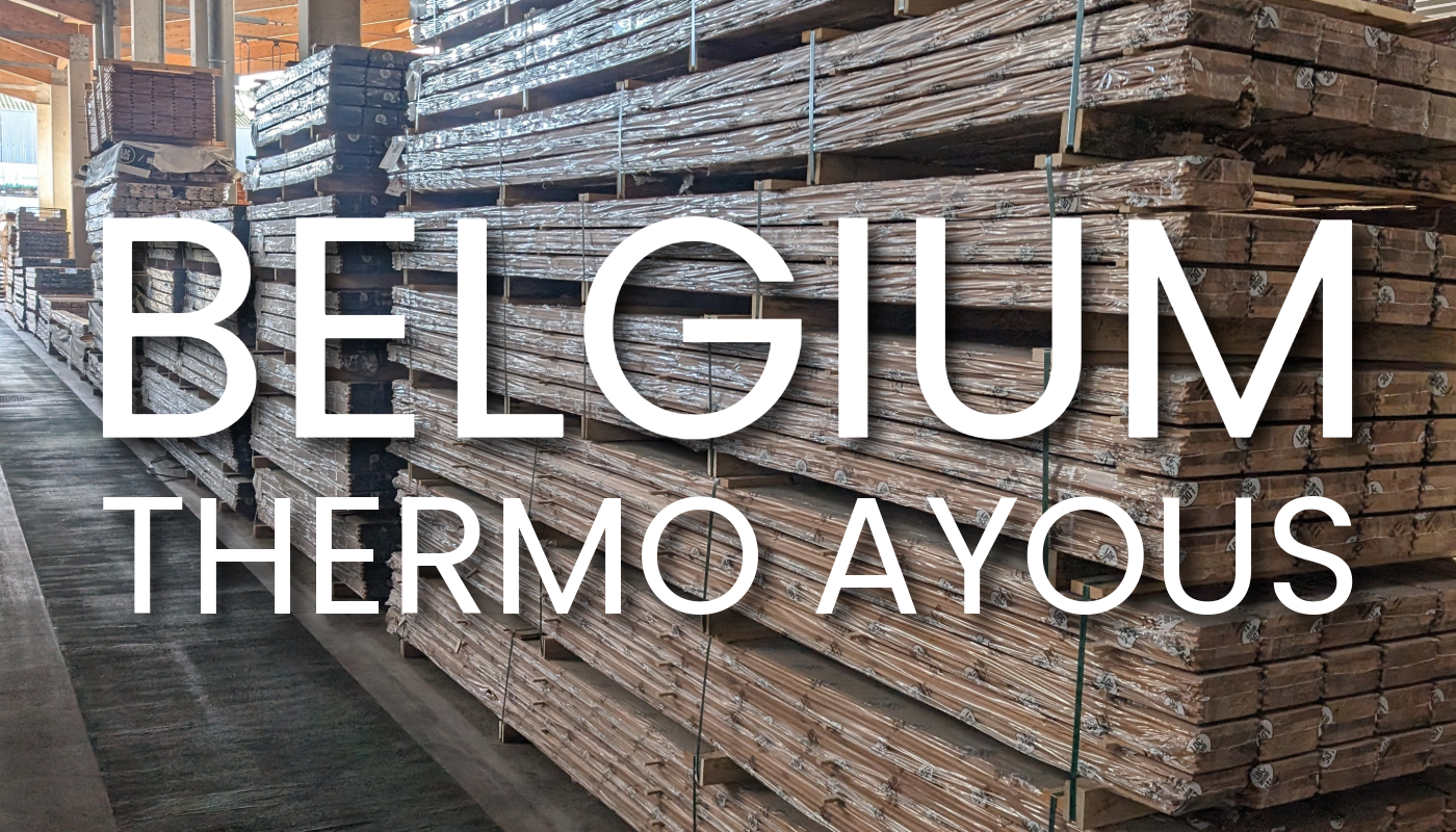 Indoor lumber warehouse with tall stacks of wrapped wooden planks; large white text overlay reads BELGIUM THERMO AYOUS across the scene.