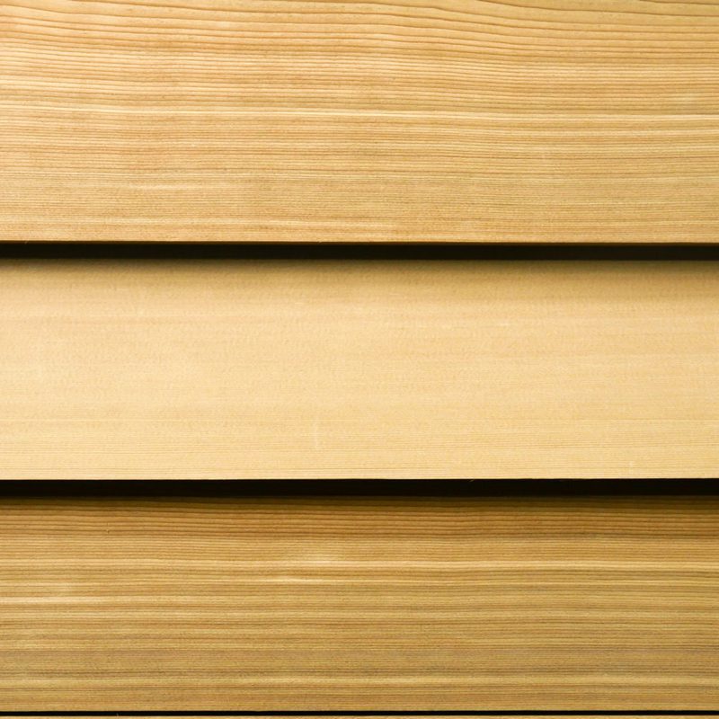 Close-up of light brown wooden planks arranged horizontally with visible grain and narrow gaps between boards.