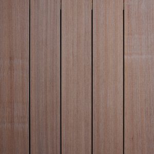 Close-up of vertical wooden planks with narrow gaps, showing warm brown wood grain and a weathered, slightly faded finish.