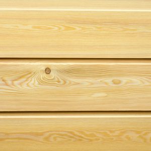 Close-up of light pine wood planks showing natural grain patterns and a knot, arranged in horizontal boards.