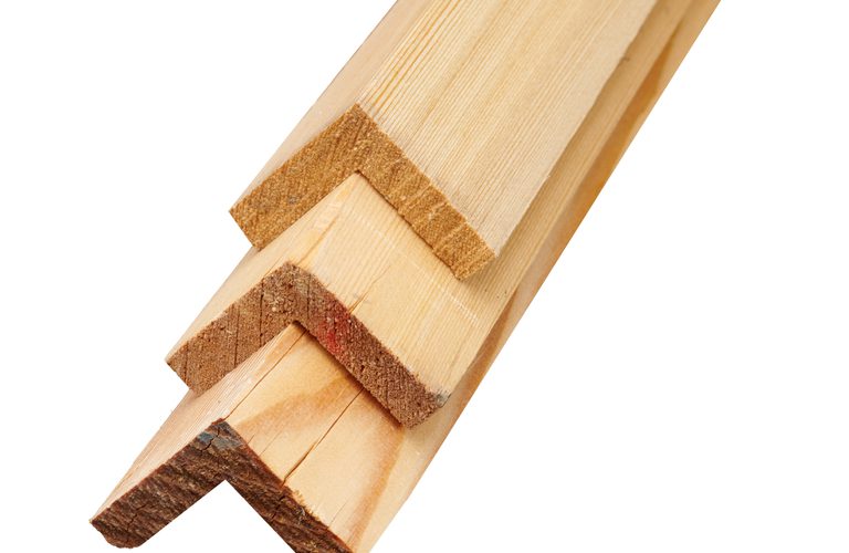 Close-up of several light wooden boards with notched ends, stacked diagonally on a white background.
