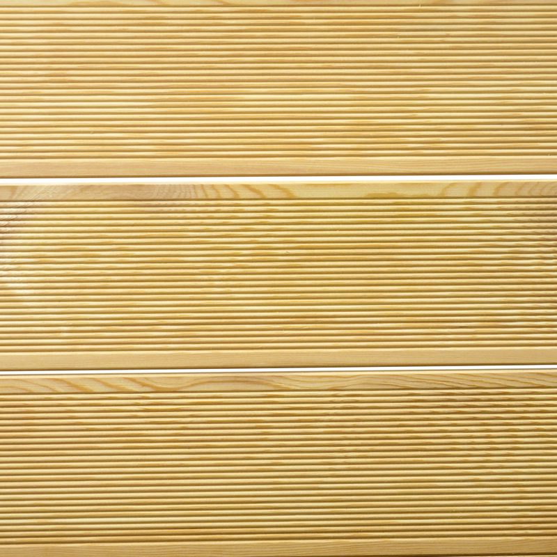 Close-up of light brown wooden planks with horizontal grooves and visible grain.