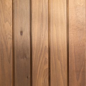 Vertical wooden planks with warm brown tones and visible grain, forming a paneled surface.