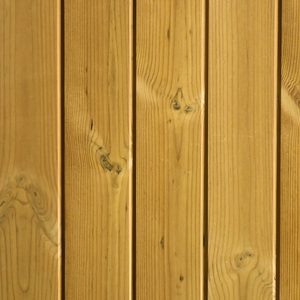 Close-up of vertical wooden planks showing natural grain patterns and knots in warm light-brown wood.