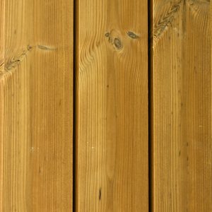 Close-up of vertical wooden boards in warm amber-brown, showing grain patterns, knots, and small gaps between planks.