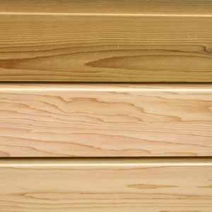 Close-up of three horizontal wooden planks with visible grain and small gaps, in natural light tan color.