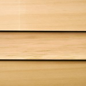 Close-up of light wood panels arranged in three horizontal planks with subtle grain and narrow gaps.