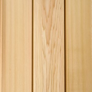 Close-up of light wooden paneling with vertical planks and visible grain patterns.