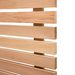Horizontal light wood slats with small gaps, forming a slatted panel against a white background; visible wood grain.